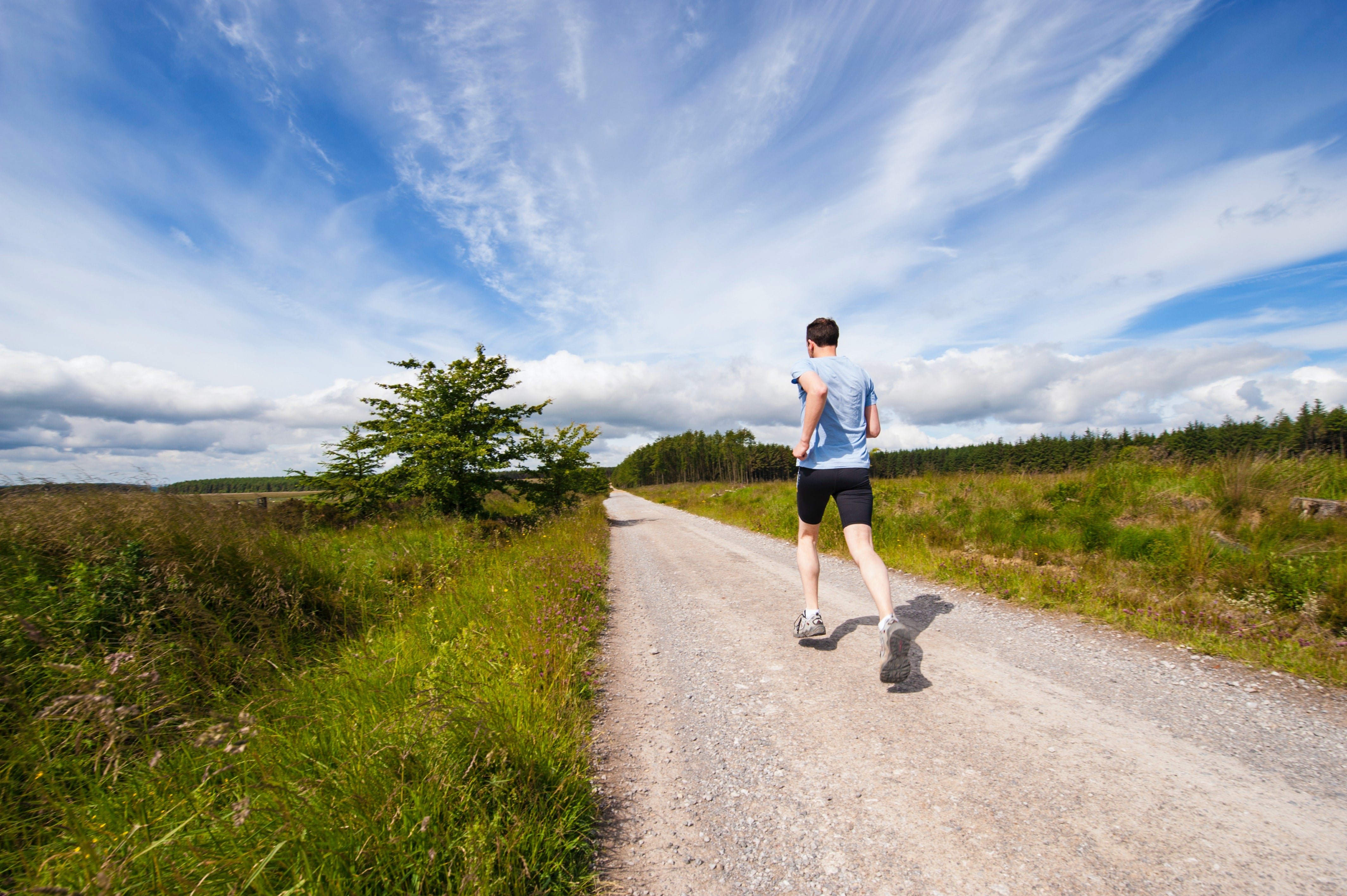 man sprinting up a hill